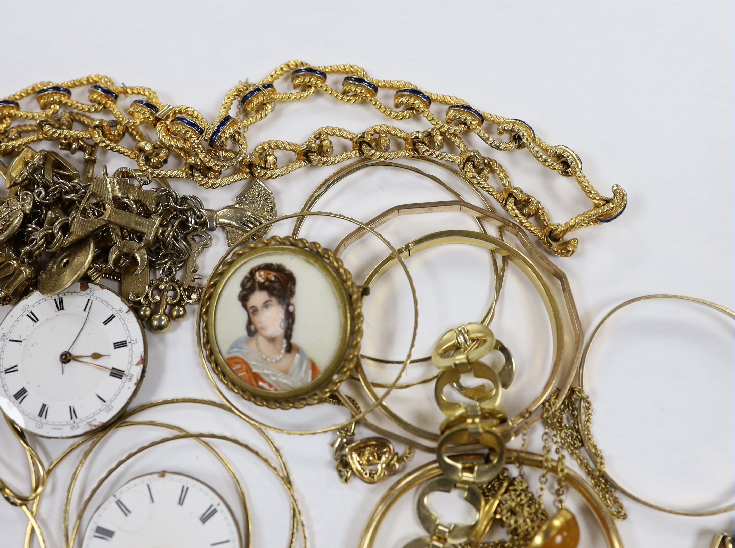 A small quantity of assorted gilt metal or gold plated jewellery, including large cub link necklace, bangles, bracelets, rings, cufflinks etc and three pocket watch movements.